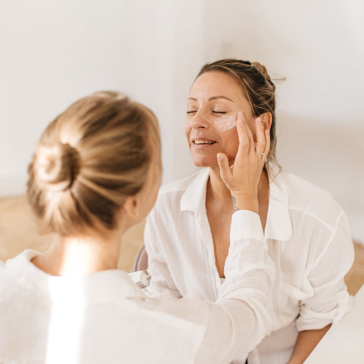 Skin specialist consulting with a client in a bright treatment room
