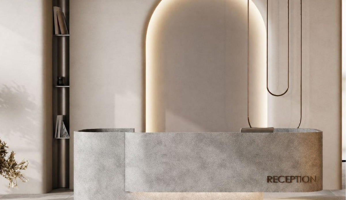 Minimal beauty salon interior with arched mirror and stone reception