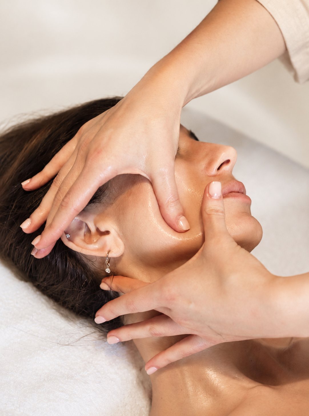 Therapist giving a client a facial massage